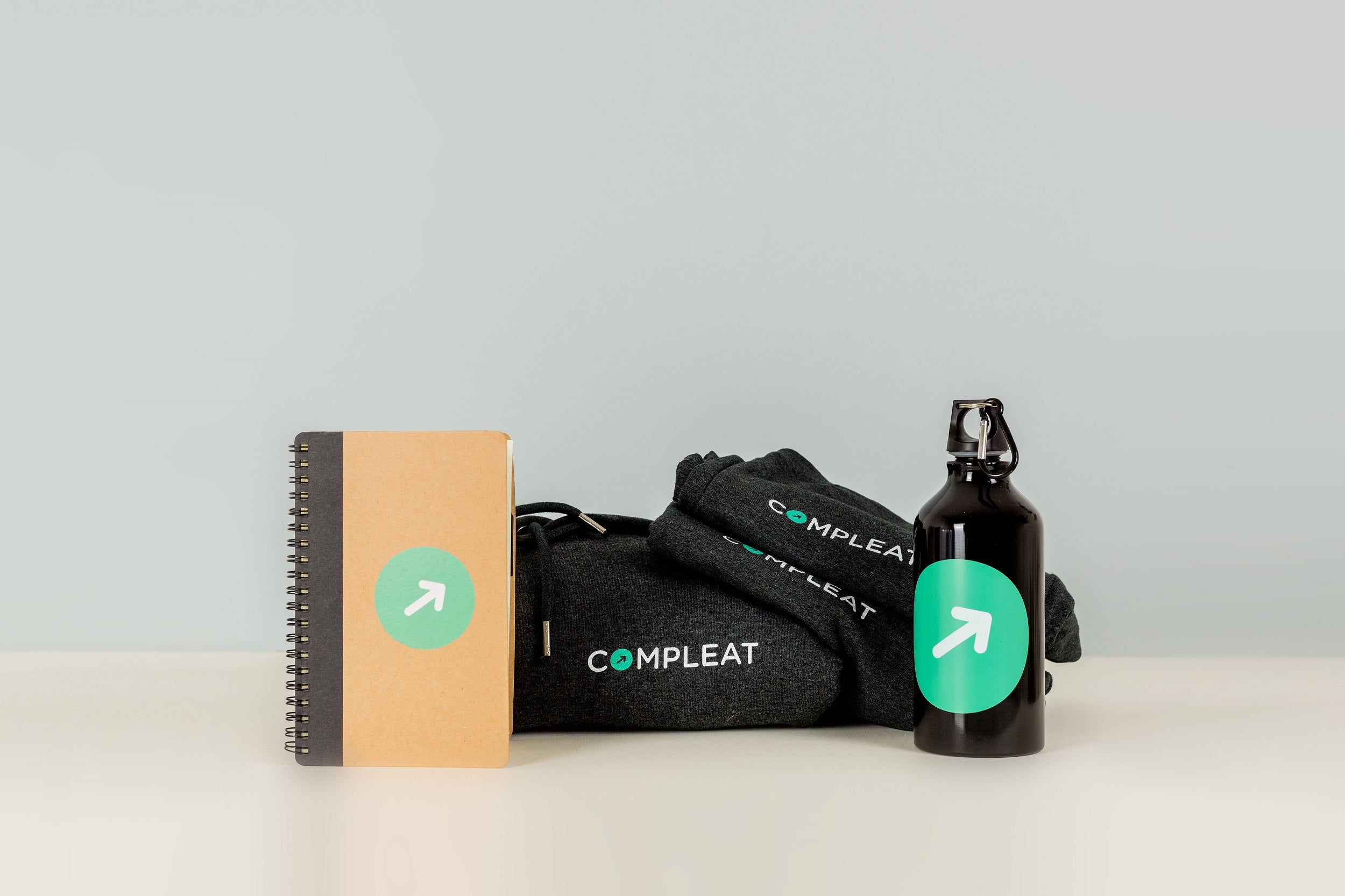 Eco-friendly Branded Corporate Gifts - An image of branded items including Hoodies, T-shirts, Water Bottles and Notebook